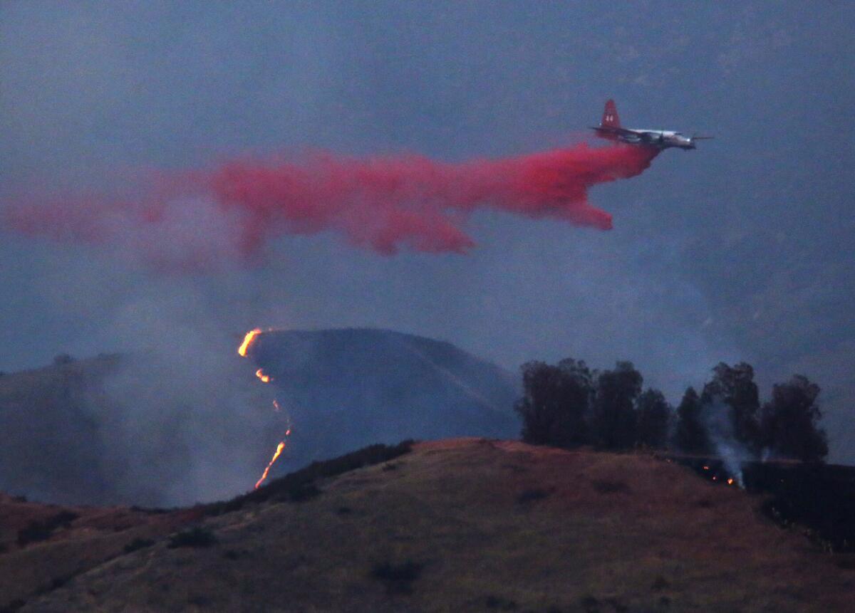 An air tanker drops flame retardant over the Sterling wildfire in the foothills above San Bernardino on June 25.