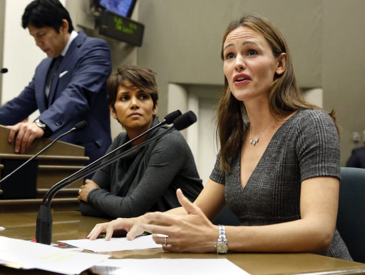 Actress Jennifer Garner, right, describes how paparazzi aggressively follow her and her three children daily, while testifying before the Assembly Judiciary Committee in support of the bill to restrict the paparazzi. Actress Halle Berry, center, also urged lawmakers to approve SB 606, by state Sen. Kevin de Leon (D-Los Angeles), standing far left.