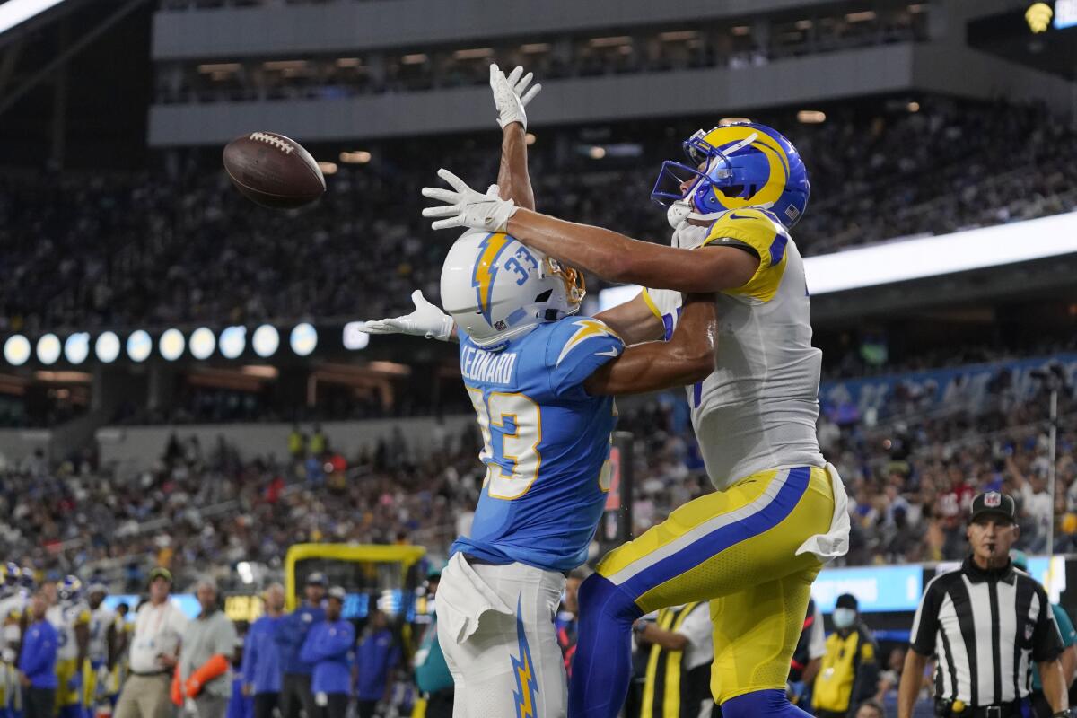 Chargers cornerback Deane Leonard, left, is called for pass interference while defending Rams wide receiver J.J. Koski.