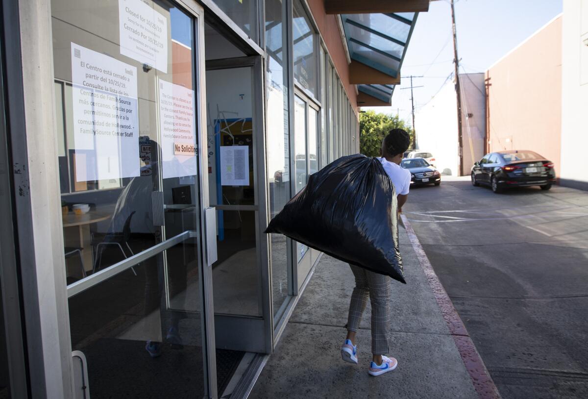 A staff member carries belonging out of the offices of the Youth Policy Institute on the day it closed.