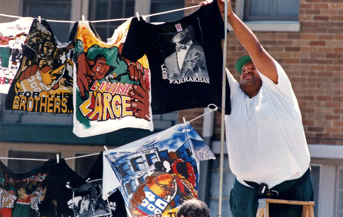 A street vendor hangs T-shirts during Freaknik