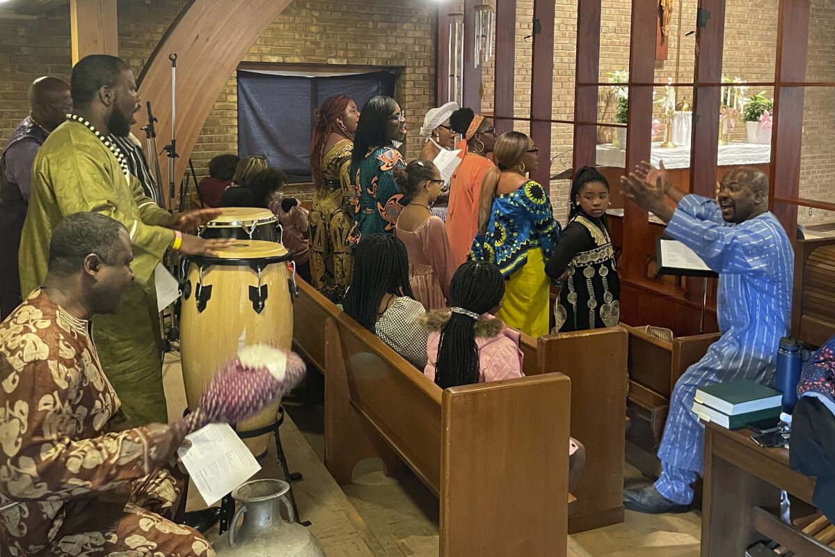 Brendan Banteh directs the Cameroonian choir for Sunday morning Easter service at St. Peter Claver in St. Paul, Minn.
