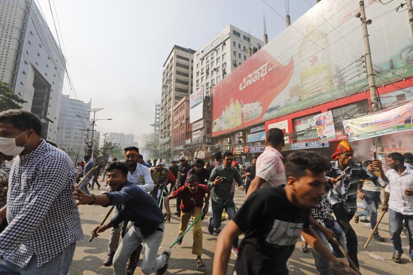 Activists of the Bangladesh Nationalist Party run after clashing with police during a protest in Dhaka, Bangladesh, Saturday, Oct. 28, 2023. Police in Bangladesh's capital fired tear gas to disperse supporters of the main opposition party who threw stones at security officials during a rally demanding the resignation of Prime Minister Sheikh Hasina and the transfer of power to a non-partisan caretaker government to oversee general elections next year. (AP Photo/Mahmud Hossain Opu)