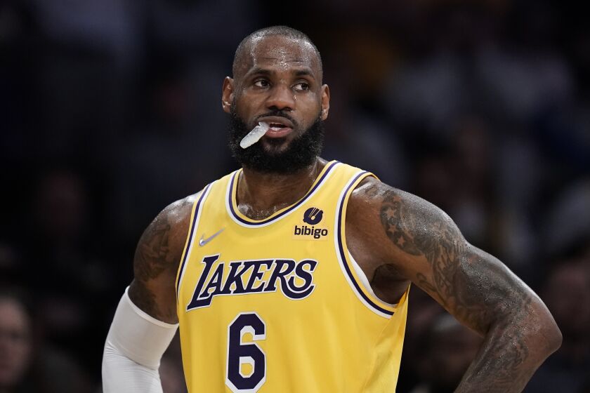 Los Angeles Lakers' LeBron James stands on the court 