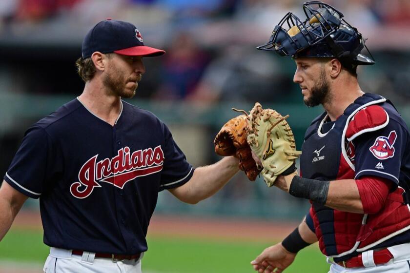 Cleveland Indians starting pitcher Josh Tomlin, left, is congratulated by catcher Yan Goes in the first inning of a baseball game against the Kansas City Royals, Thursday, Sept. 14, 2017, in Cleveland. (AP Photo/David Dermer)