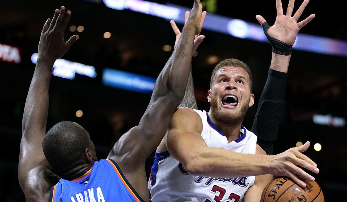 Clippers power forward Blake Griffin is fouled as he tries to shoot over Thunder power forward Serge Ibaka in the second quarter Thursday night at Staples Center.