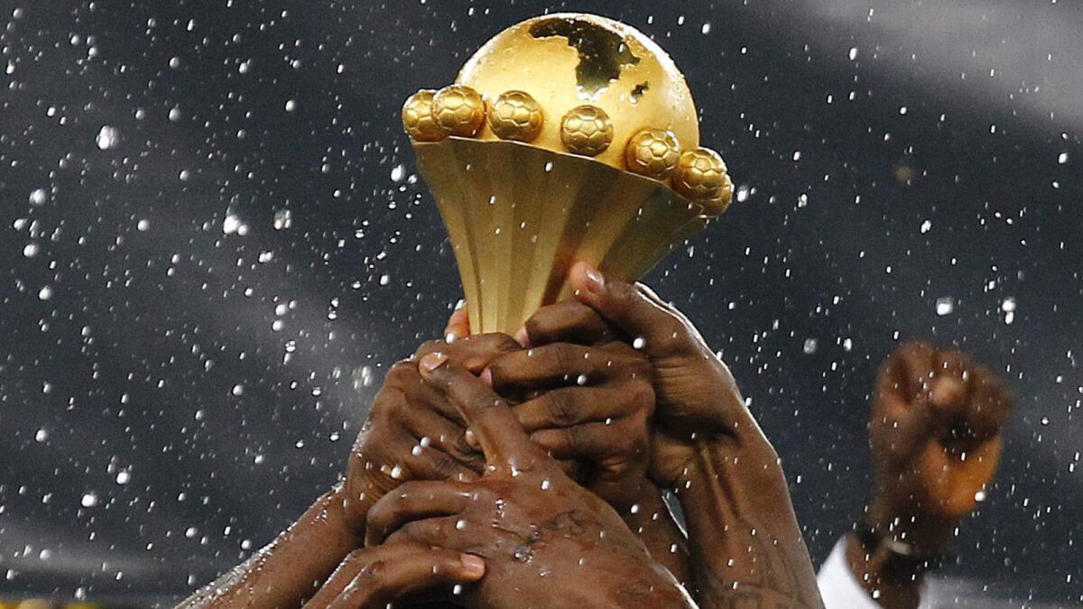 Nigerian national soccer team players hoist the Africa Cup trophy into the air following their 2013 championship win over Burkina Faso in South Africa.