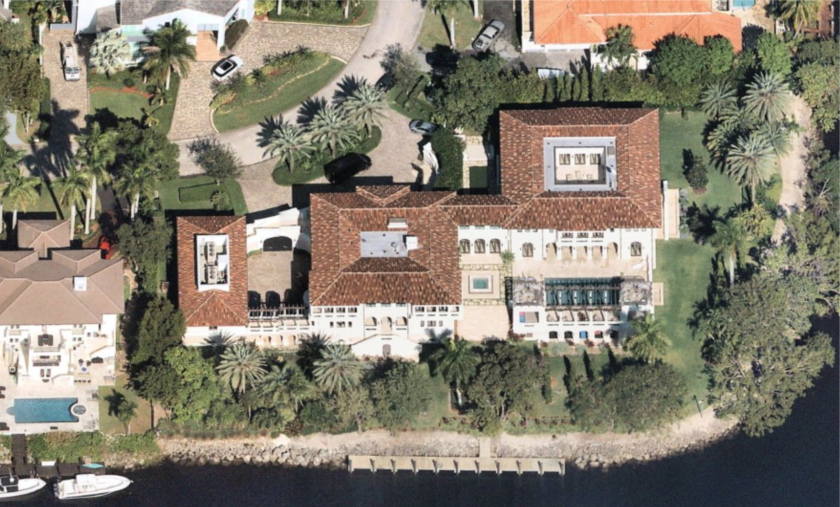 An aerial view shows the 17,000-square-foot mansion and its water frontage.