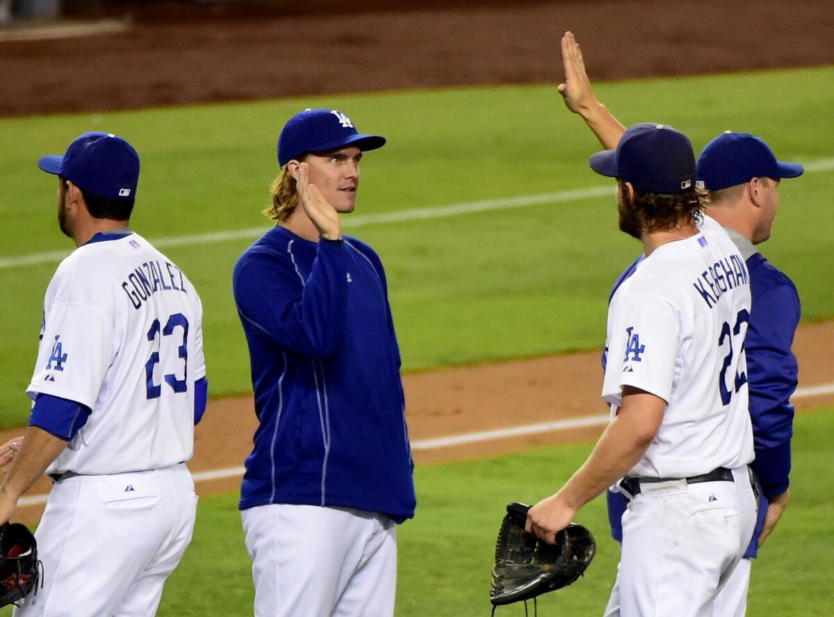 Zack Greinke high fives Clayton Kershaw after Wednesday's victory.