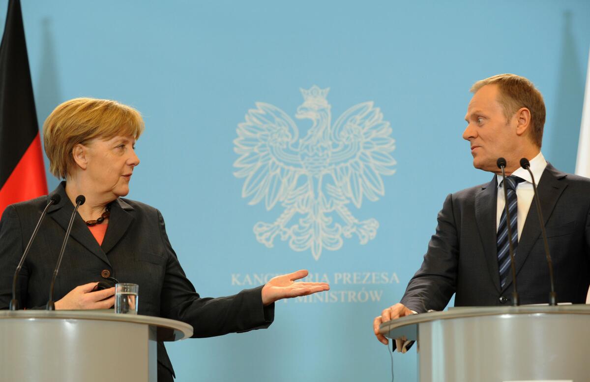 German Chancellor Angela Merkel and Polish Prime Minister Donald Tusk hold a news conference after emergency consultations on the Ukraine crisis on Wednesday in Warsaw.