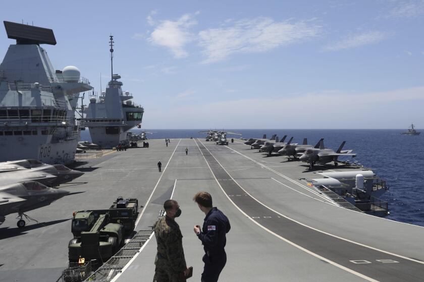 Military personnel participate in the NATO Steadfast Defender 2021 exercise on the deck of the aircraft carrier HMS Queen Elizabeth off the coast of Portugal, Thursday, May 27, 2021. As tensions with Russia simmer, thousands of NATO troops, several warships and dozens of aircraft are taking part in military exercises stretching across the Atlantic, through Europe and into the Black Sea region. The war-games, dubbed Steadfast Defender 2021, are aimed at simulating the 30-nation military organization's response to an attack on any one of its members. (AP Photo/Ana Brigida)
