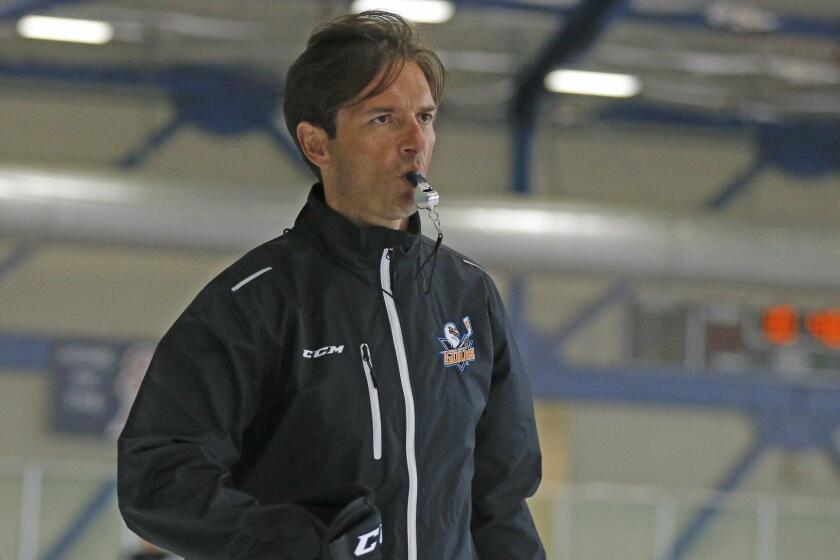ADVANCE FOR USE SATURDAY, OCT. 10 - San Diego Gulls coach Dallas Eakins watches during hockey practice, Thursday, Oct. 8, 2015, in San Diego. Less than a year removed from being fired in mid-season by the Edmonton Oilers, Eakins professes not to be in a rush to get back to the NHL as he begins to develop the top farm team for the Anaheim Ducks, who play just 90 minutes up the freeway. (AP Photo/Lenny Ignelzi)