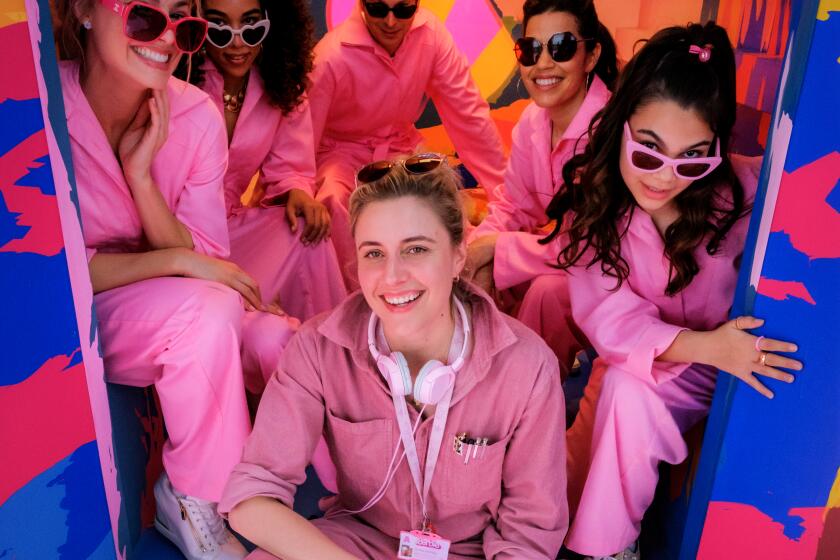Greta Gerwig and the cast of a 'Barbie' poste for the photo in the back of a pink truck from the movie
