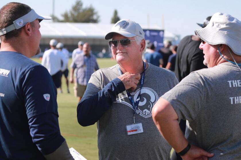 IRVINE, CALIF. -- MONDAY, AUGUST 13, 2018: Rams defensive coordinator Wade Phillips, center, talks to fellow coaches at the Los Angeles Rams training camp at UC-Irvine in Irvine, Calif., on Aug. 13, 2018. (Allen J. Schaben / Los Angeles Times)