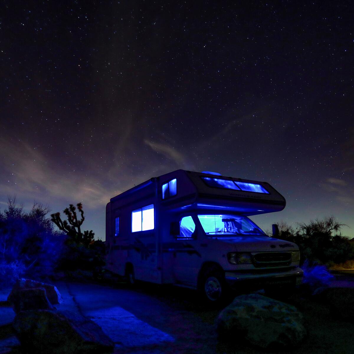 An RV camper and night sky in Joshua Tree National Park 
