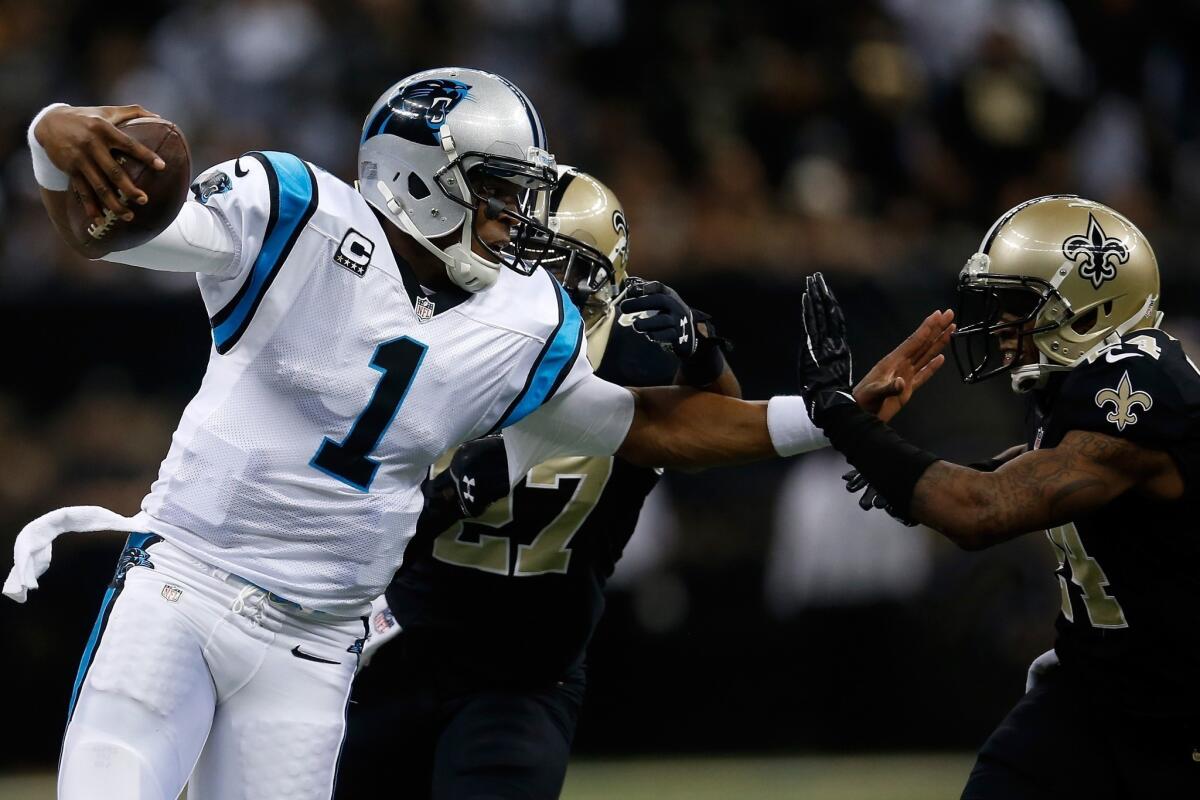 Carolina Panthers quarterback Cam Newton is tackled by New Orleans Saints free safety Malcolm Jenkins, center, during a 31-13 loss on Dec. 8. Newton and the Panthers hope to have better luck against their NFC South rivals on Sunday.