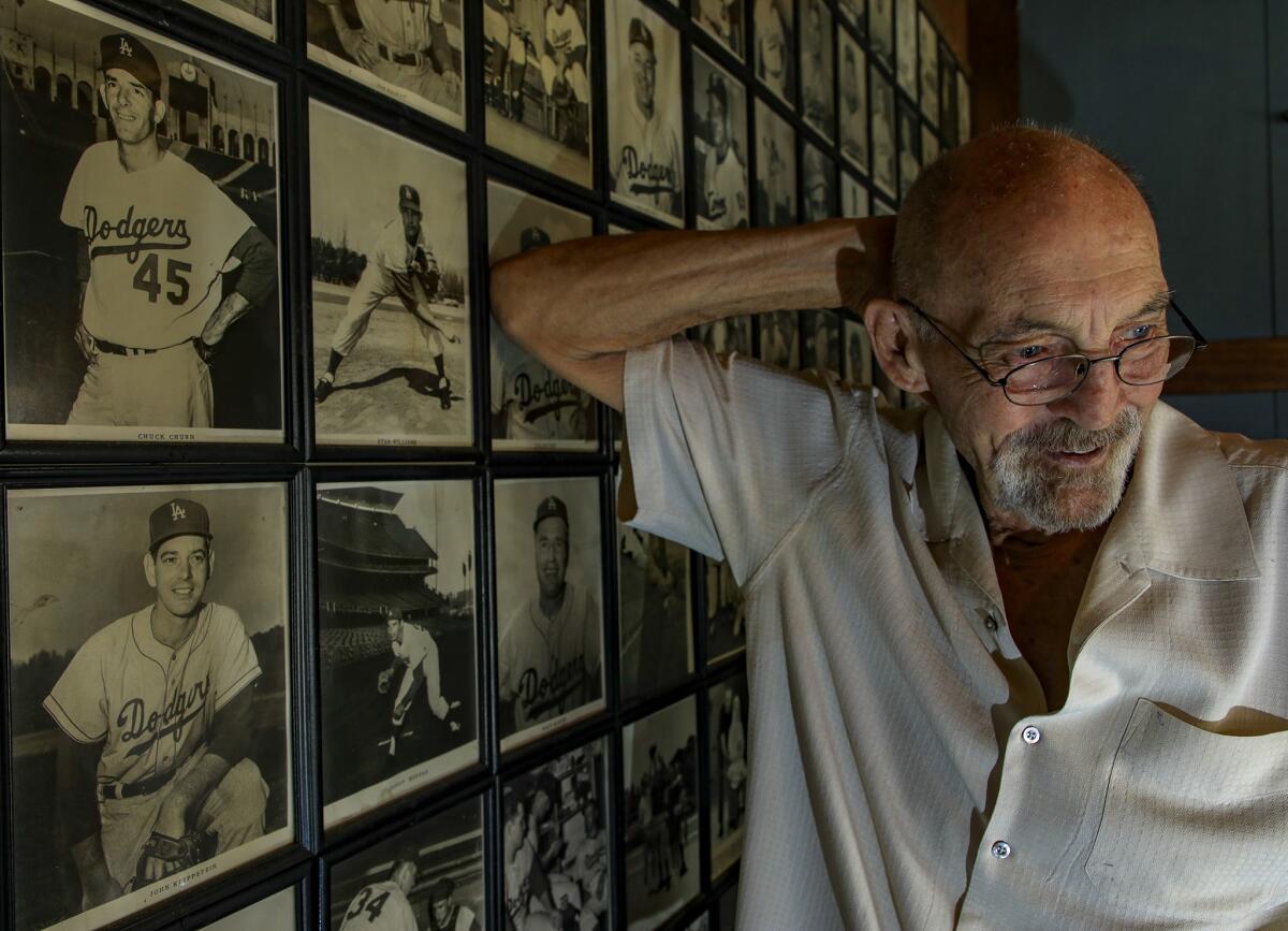 Former Dodger starting pitcher Stan Williams sits next to a wall of photos in his Lakewood garage depicting himself, along with former teammates primarily from the Dodgers and Yankees August 24, 2018. Stan Williams was a pitcher who spent 14 years in the big leagues, mostly with two high-profile teams, the Los Angeles Dodgers and the New York Yankees. He broke into the majors with the Dodgers, in the same rotation with Sandy Koufax, Don Drysdale, and Johnny Podres.