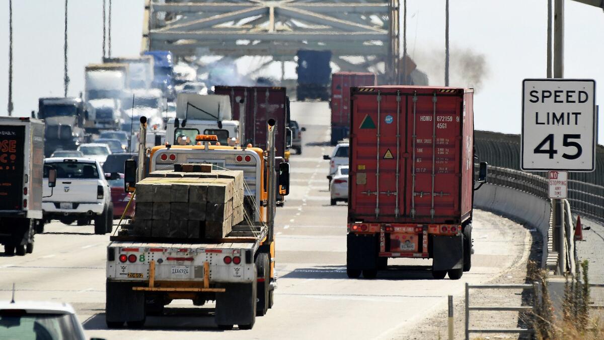 Trucks make their way up the Gerald Desmond Bridge at the Port of Los Angeles on July 19.