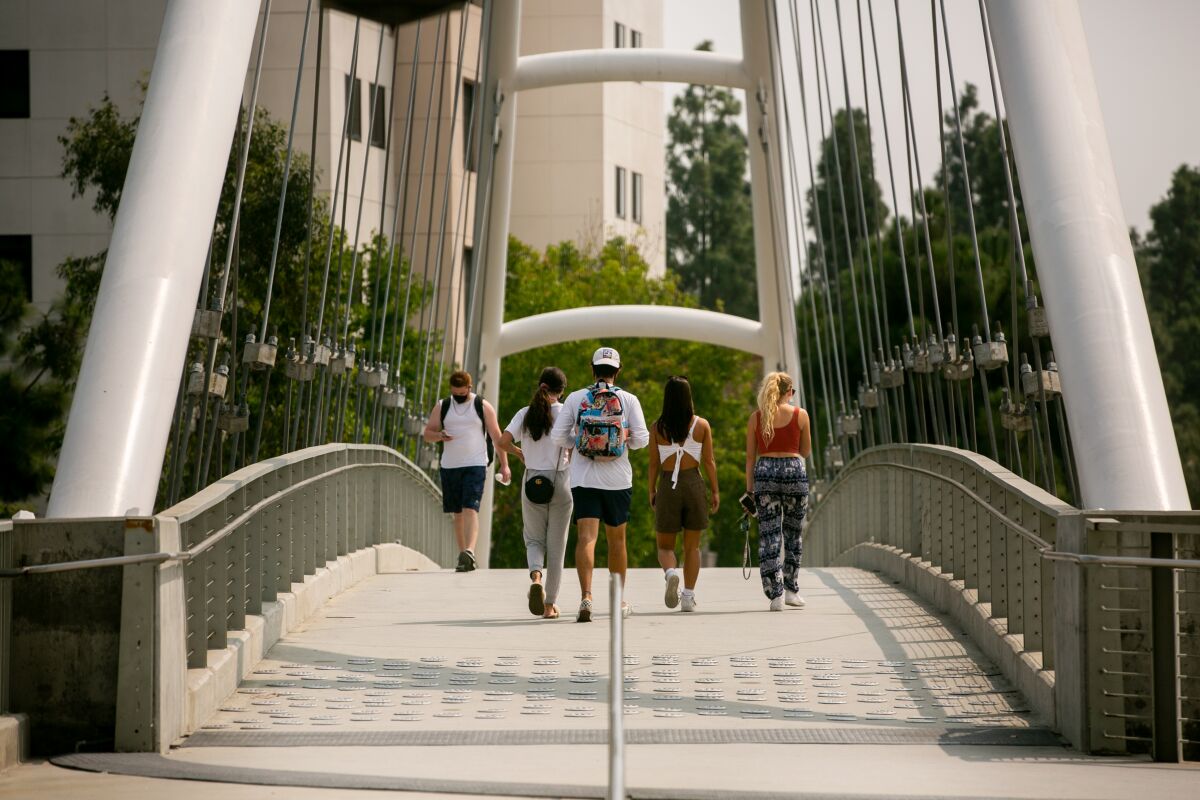 People walk across the campus of San Diego State University on Monday.