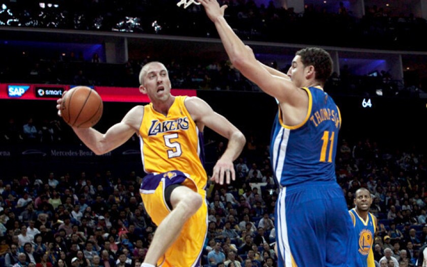 Veteran Steve Blake, elevating for a pass around Warriors guard Klay Thompson, is one of three Lakers averaging four assists a game in the preseason.