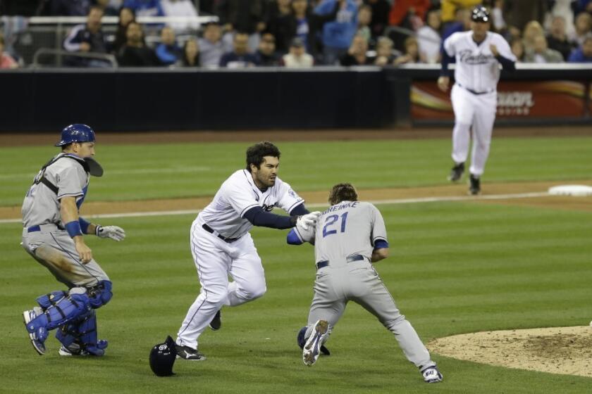 Carlos Quentin charges at Zack Greinke after being hit by a pitch.