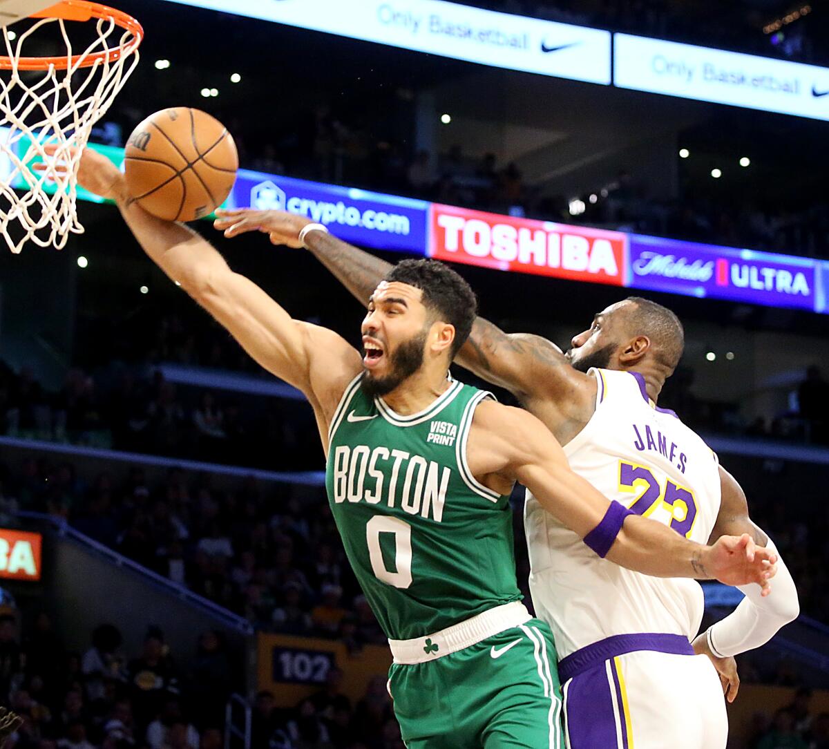 Lakers forward LeBron James, right, blocks a dunk attempt by Celtics forward Jayson Tatum.