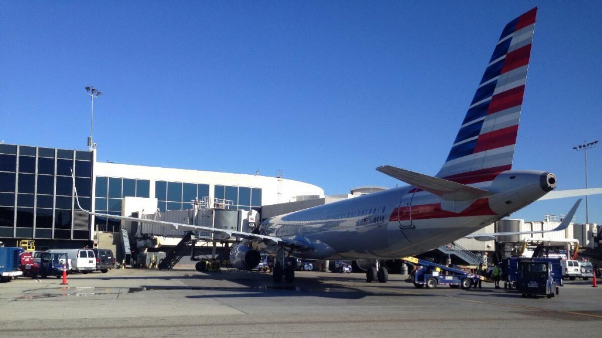 An American Airlines plane waits to take off from Los Angeles International Airport.