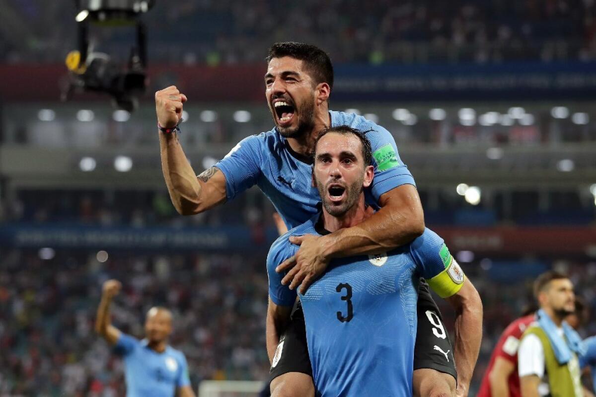Diego Godin and Luis Suarez of Uruguay celebrate victory over Portugal in the round of 16 on June 30.