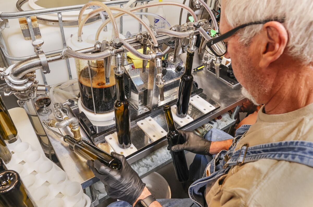 On the production line, Biff Beltz bottles mead at Lost Cause Meadery in San Diego on March 9.