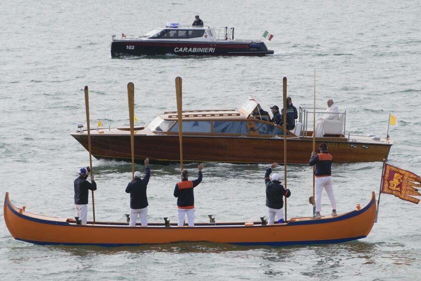 Pope Francis is greeted by Gondoliers upon his arrival in Venice, Italy, Sunday, April 28, 2024. The Pontiff arrived for his first-ever visit to the lagoon town including the Vatican pavilion at the 60th Biennal of Arts. (AP Photo/Alessandra Tarantino)