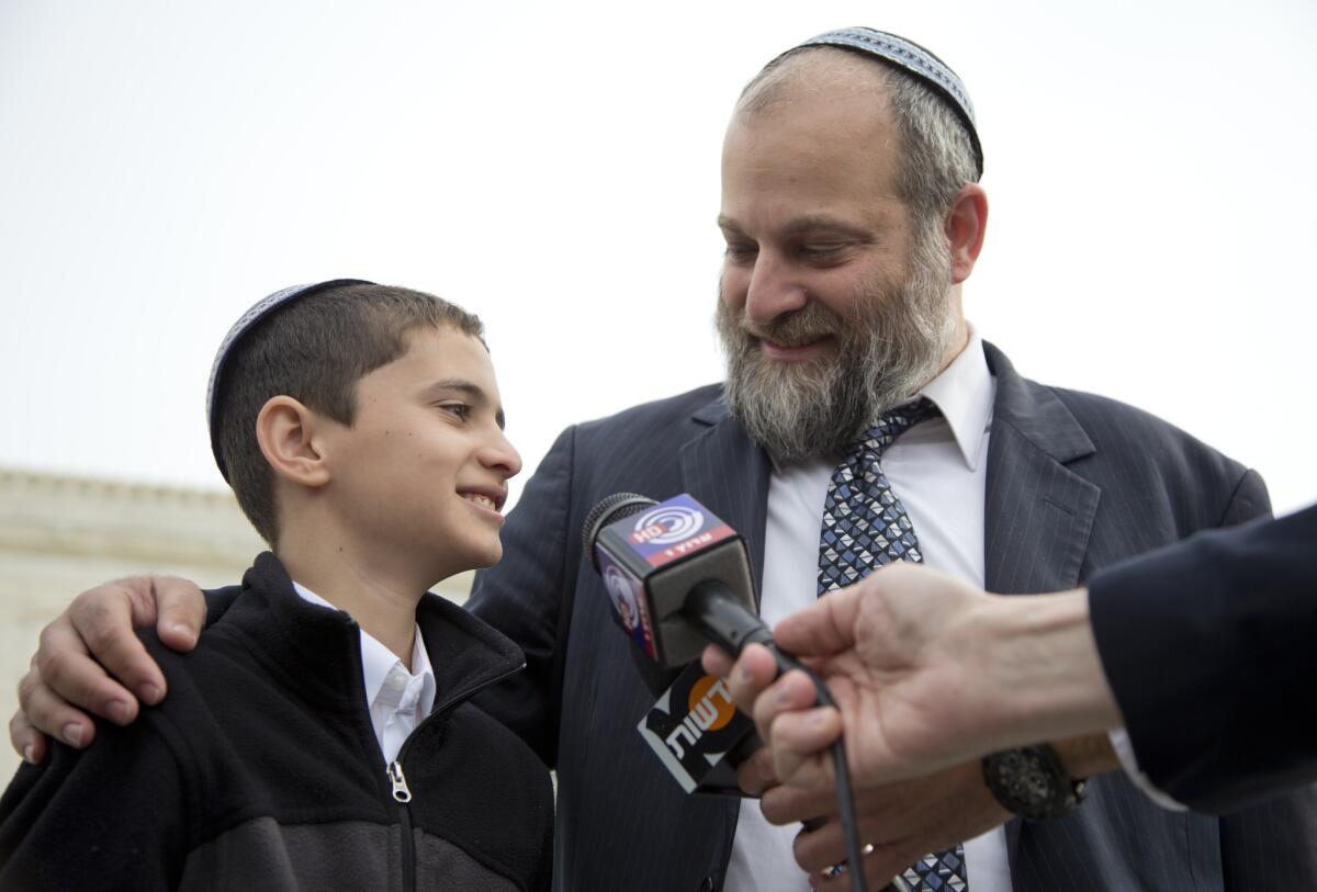 Menachem Zivotofsky stands with his father Ari Zivotofsky to speak to media outside the Supreme Court on Nov. 3, 2014.