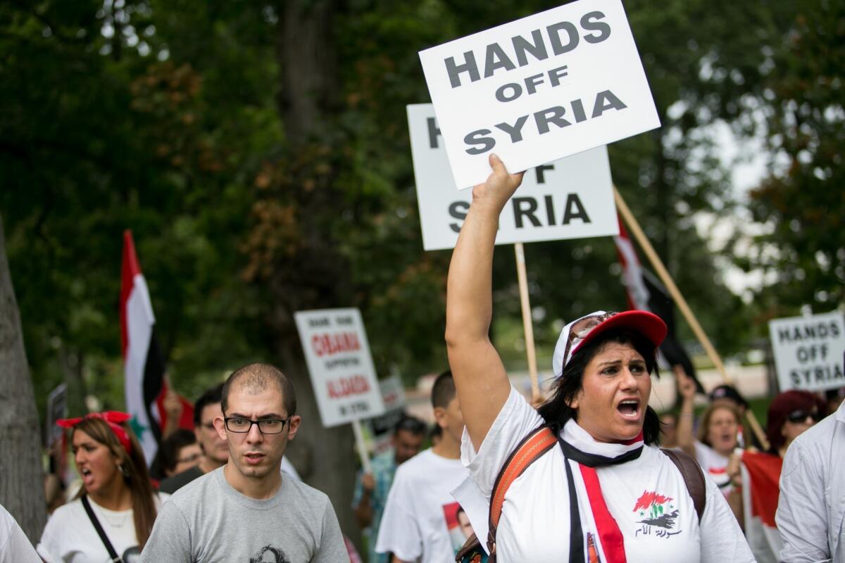 Demonstrators rally in Washington against any possible U.S. military action in Syria. President Obama will address the American people on Syria from the White House on Tuesday.
