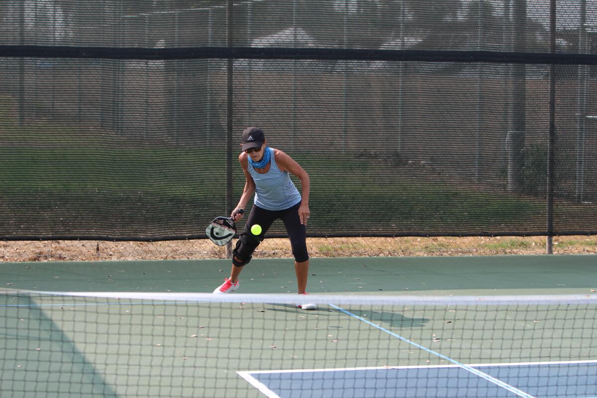 Kate Frankel takes a swing during a game of pickleball.