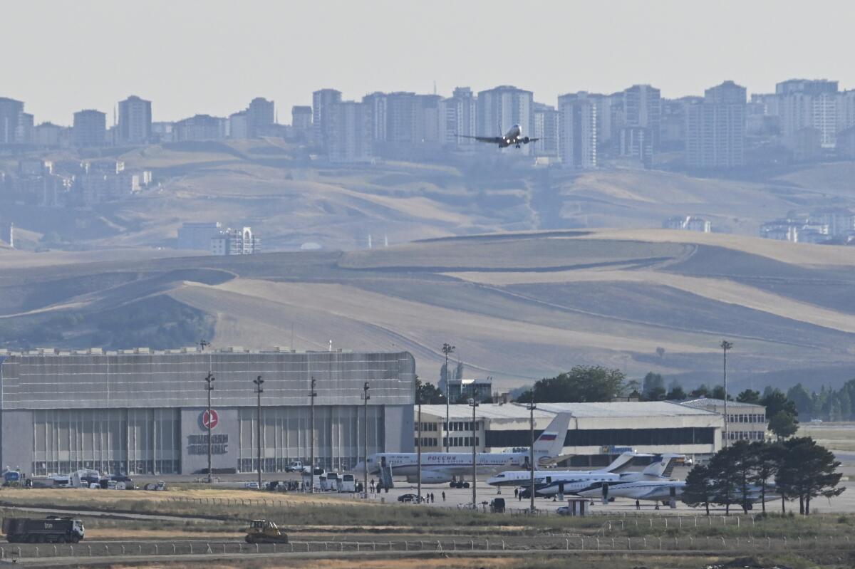 A plane flies overhead at an airport 