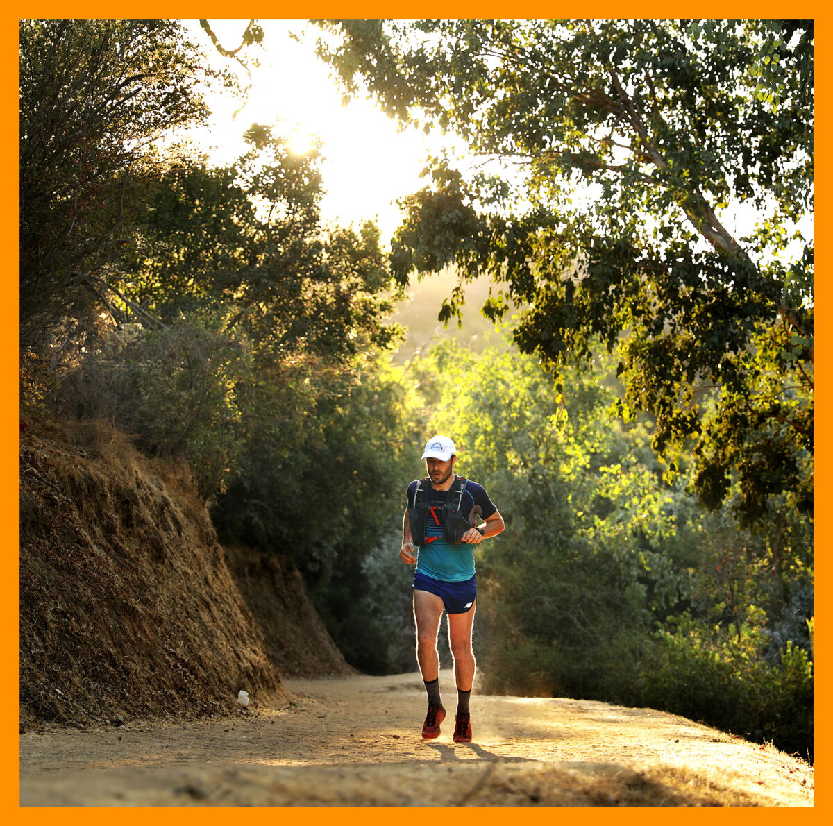 A man in a baseball hat jogs in Amir's Garden at Griffith Park.