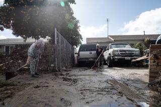 Residents clean their homes after heavy rain Monday caused flooding.