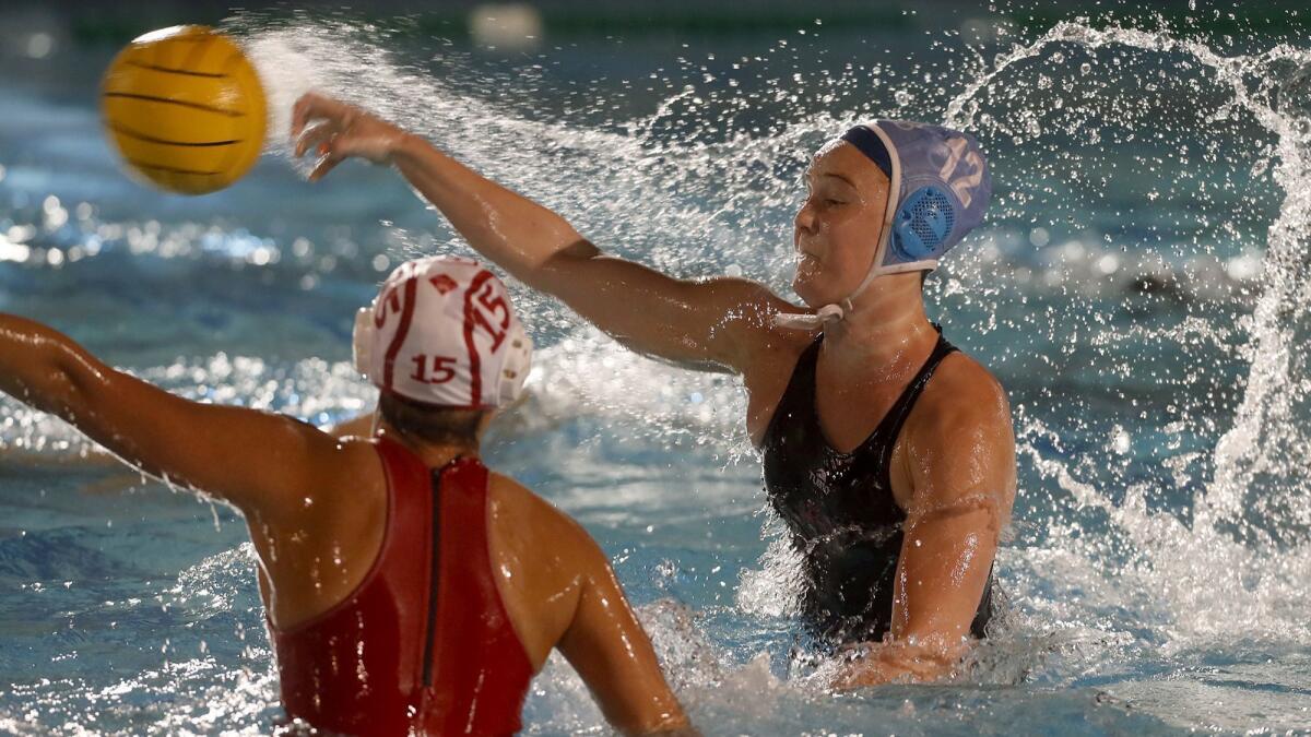 CdM’s Sophie Wallace, left, fires for the net against Orange Lutheran during the first half in a nonleague match at Corona del Mar High on Tuesday. The Sea Kings won 12-9.