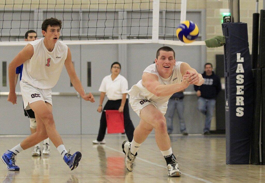 Orange Coast College's Jim Webb, right, keeps the ball in play against Santa Monica in the 2014 California Community College Athletic Assn. State Championship match at Santiago Canyon College in Orange on Friday.