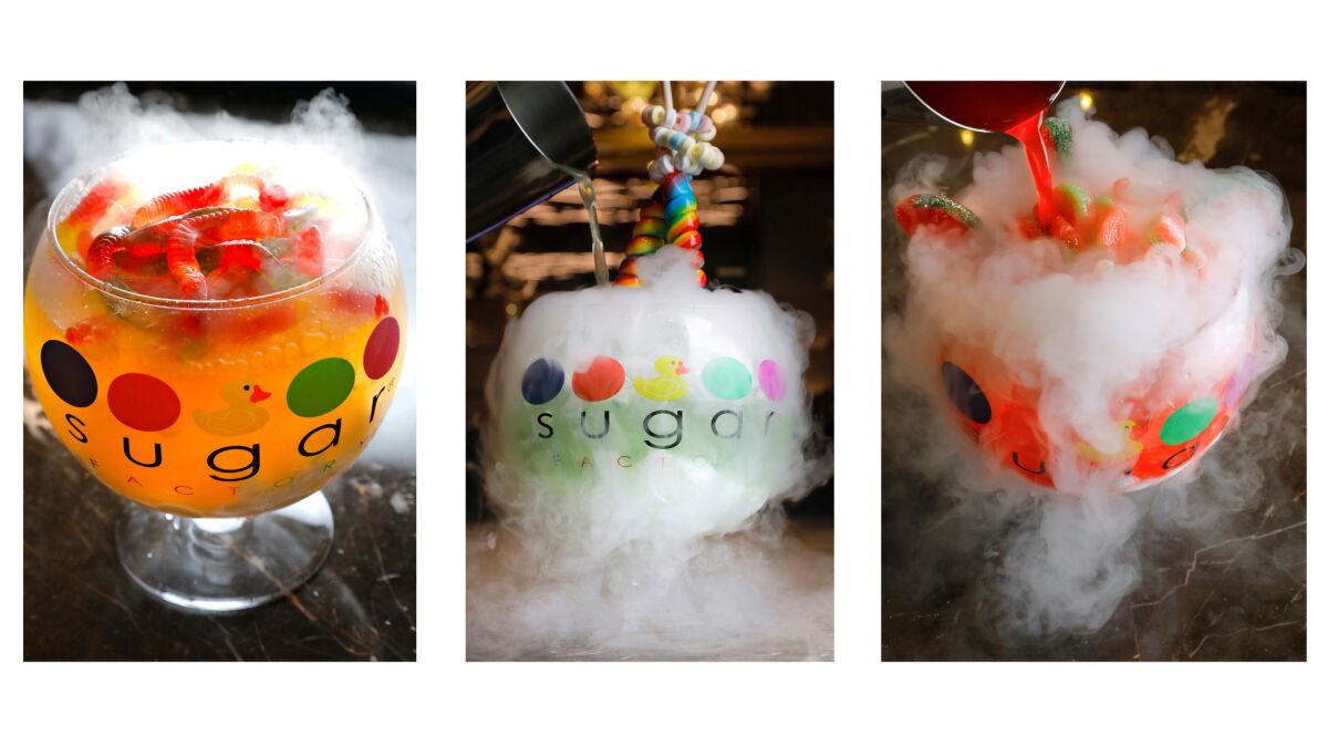 The bubbling, $39 60-ounce cocktail goblets at Sugar Factory are fueled by dry ice and ready for their social media close-ups. From left are the White Gummi, the Lollipop Passion and the Watermelon Patch. Smaller versions are available at the movie theater.