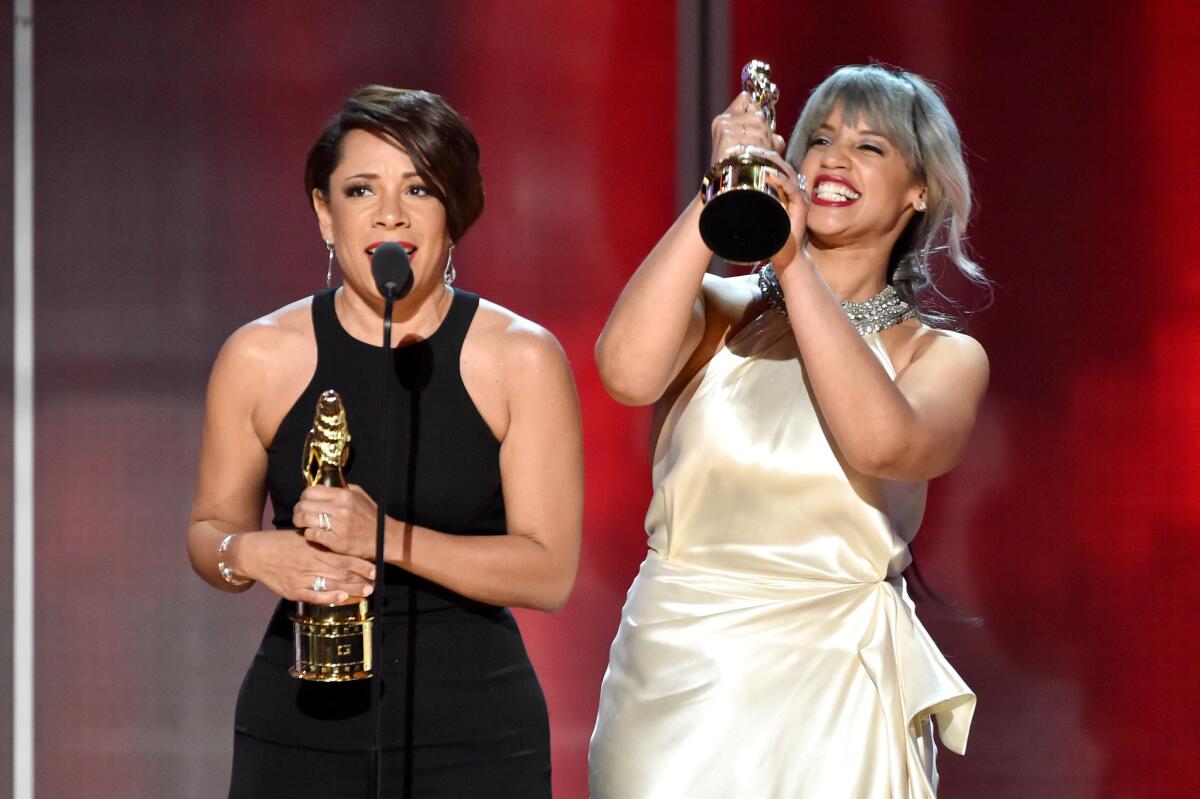 Actresses Selenis Leyva, left, and Dascha Polanco accept the Special Achievement in Televison Award on behalf of the cast of "Orange Is the New Black."