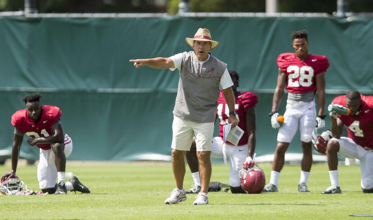 Alabama Coach Nick Saban gives instructions to players during a practice.
