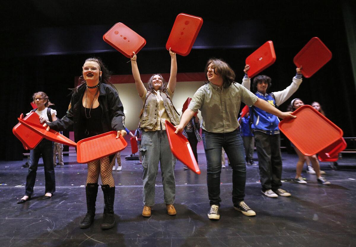 Cast members rehearse a scene Tuesday for the upcoming production of "Mean Girls" at the Costa Mesa High School theater.