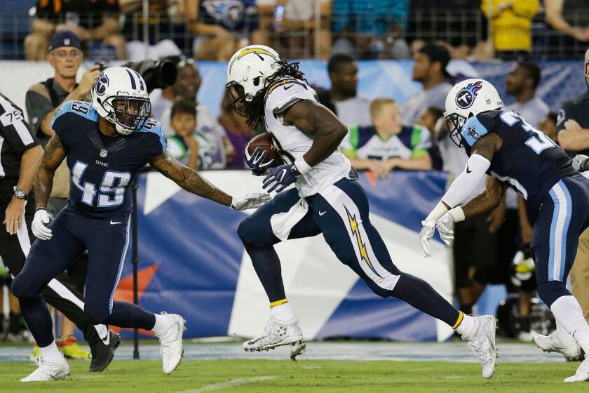 San Diego Chargers running back Melvin Gordon (28) runs toward the end zone as Tennessee Titans tight end Alex Ellis (49) and Tennessee Titans running back David Fluellen (32) defend during the first half of an NFL preseason football game, Saturday, Aug. 13, 2016, in Nashville, Tenn. Gordon scored a touchdown on the play. (AP Photo/James Kenney)