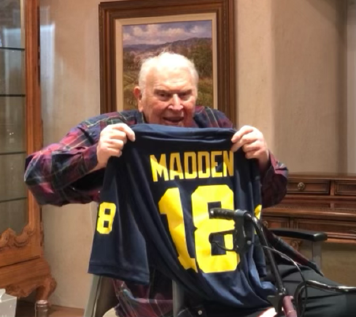 John Madden holds up a Jesse Madden Michigan jersey.