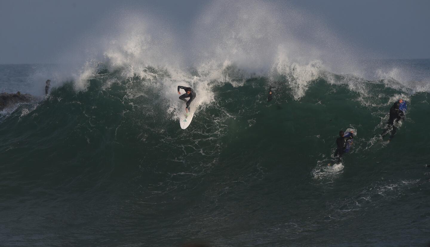 A surfer drops into the peak of a giant wave Wednesday at the Wedge in Newport Beach, where swells generated from storms in the South Pacific days earlier attracted surfers looking to challenge the big waves.