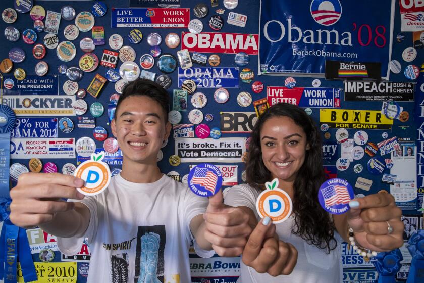 ORANGE, CALIF. -- MONDAY, AUGUST 5, 2019: Interns Lucas Uhm, left, and Andrea Madrid help register Orange County democratic voters at the Democratic Party of Orange County in Orange, Calif., on Aug. 5, 2019. (Allen J. Schaben / Los Angeles Times)