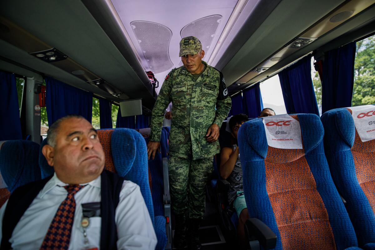 Mexican immigration officials and members of the newly deployed National Guard check IDs and search for undocumented travelers at a checkpoint near Comitan, Mexico, on June 24, 2019.