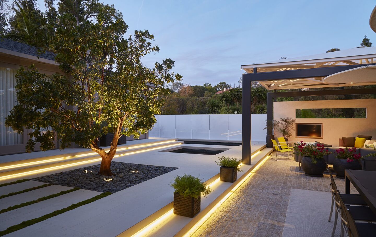 Linear strips of LED lighting define terraces. The lighting by Gannon Electric Light.