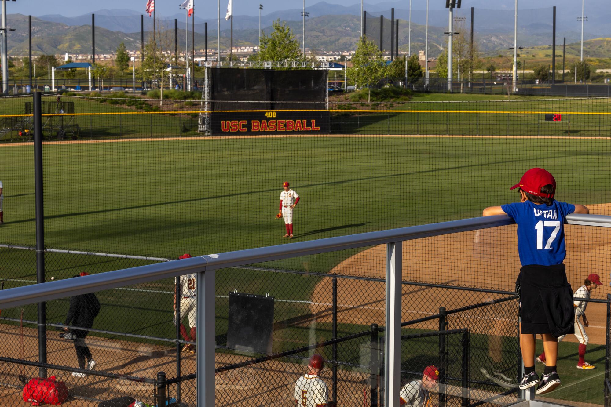 Tre Burkitt, 8, watches the USC baseball team warm up before a game with Cal at the Great Park in Irvine on May 3.