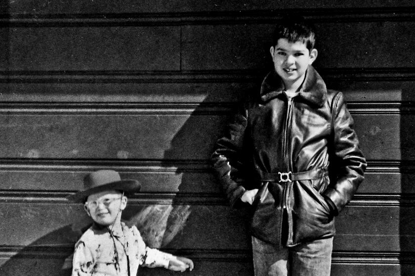 Steve, wearing cowboy duds at 4½ , Mike at 12. Denver, 1955.
